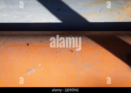 Sandy background, orange and grey painted colored and shaded surface Stock Photo