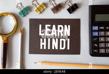 learn Hindi language sign on black background. Stock Photo