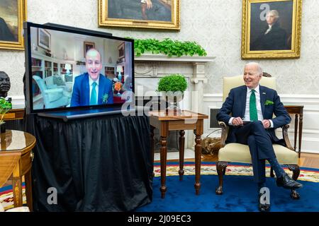Washington DC, USA. 17th Mar, 2022. Washington DC, USA. 17 March, 2022. U.S President Joe Biden chats with Irish Prime Minister Micheal Martin by video conference to mark St Patricks Day with the traditional bowl of shamrocks from the Oval Office of the White House, March 17, 2022 in Washington, DC The Prime Minister was unable to attend the annual event in his honor after testing positive for COVID-19. Credit: Adam Schultz/White House Photo/Alamy Live News Stock Photo