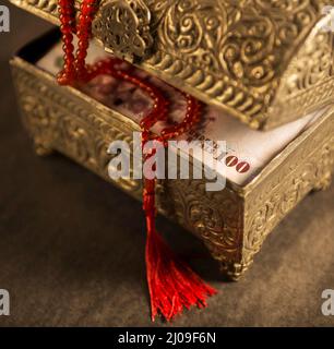 Close of Hundred Saudi Riyals in an ornamental box along with islamic rosary.Donation during Ramadan -Saudi Riyals. Stock Photo