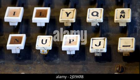 Well worn keys of Linotype Machine line bottom of image. Letters are ...