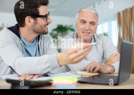 different generations 60s and man using pc Stock Photo