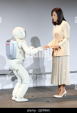 Tokyo, Japan. 17th Mar, 2022. Japanese blind scientist and chief executive director of the National Museum of Emerging Science and Innovation (Miraikan) Chieko Asakawa (R) thanks to Honda Motor's humanoid robot ASIMO as ASIMO graduates the Miraikan after he worked as a staff, science communicator for 20 years at the Miraikan in Tokyo on Thursday, March 17, 2022. He greeted many VIPs including US President Barack Obama at the Miraikan to show his performance. Credit: Yoshio Tsunoda/AFLO/Alamy Live News Stock Photo
