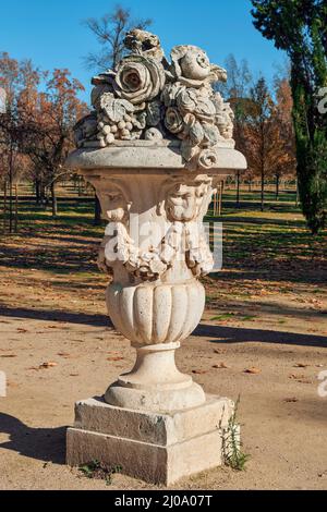 ornamental white stone cup with flowers adorning the walk in the Jardin del Principe in the city of Aranjuez, province of Madrid, Spain, Europe Stock Photo