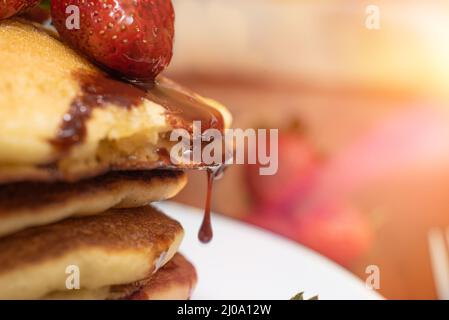 Closeup of a strawberry dripping chocolate syrup Stock Photo