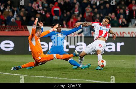 Belgrade, Serbia. 17th Mar, 2022. Red Star Belgrade's Ohi Omoijuanfo (R) vies with Glasgow Rangers' Allan McGregor (L) and Calvin Bassey during the UEFA Europa League round of 16 second leg football match between Red Star Belgrade (Crvena Zvezda) and Glasgow Rangers in Belgrade, Serbia, March 17, 2022. Credit: Predrag Milosavljevic/Xinhua/Alamy Live News Stock Photo