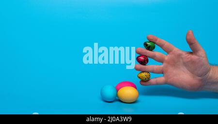 Easter eggs and fingers with quail eggs Stock Photo