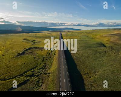 Beautiful cinematic aerial view of the great lonely highways crossing between mountains and nature, in Iceland Stock Photo