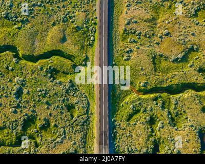 Beautiful cinematic aerial view of the great lonely highways crossing between mountains and nature, in Iceland Stock Photo