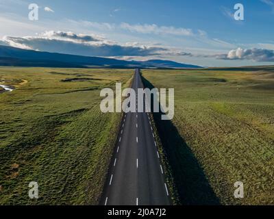 Beautiful cinematic aerial view of the great lonely highways crossing between mountains and nature, in Iceland Stock Photo