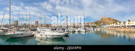 Alicante Port d'Alacant marina with boats and view of castle Castillo travel traveling holidays vacation at Mediterranean Sea panorama in Spain Stock Photo