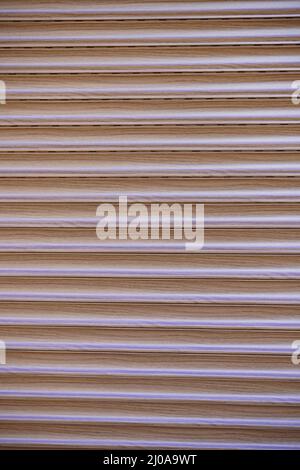 Close up vertical shot of roller blinds with brown color, Security protection shutters Stock Photo