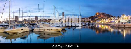 Alicante Port d'Alacant marina with boats and view of castle Castillo Mediterranean Sea twilight travel traveling holidays vacation panorama in Spain Stock Photo