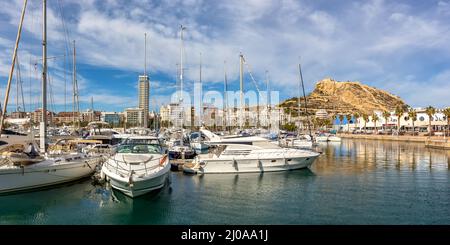 Alicante Port d'Alacant marina with boats and view of castle Castillo travel traveling holidays vacation at Mediterranean Sea panorama in Spain Stock Photo