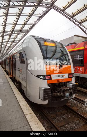 Cologne, Germany - August 3, 2021: Rhein Ruhr Xpress RRX train Siemens Desiro HC type at Köln main railway station Hauptbahnhof Hbf portrait format in Stock Photo