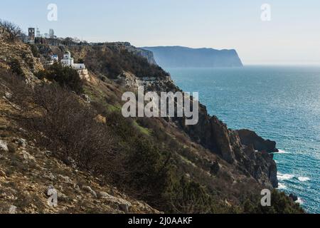 View of Crimean rugged rocky shore with Saint George Monastery in spring sunny day. Sevastopol, Crimea Stock Photo