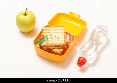 https://l450v.alamy.com/450v/2j0aatc/yellow-lunch-box-with-toasted-slices-of-bread-cheese-a-bottle-of-water-and-a-green-apple-school-breakfast-top-view-2j0aatc.jpg