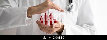 Close-up Of Doctor's Hand Protecting The Blue Family Paper Cut Out Stock Photo