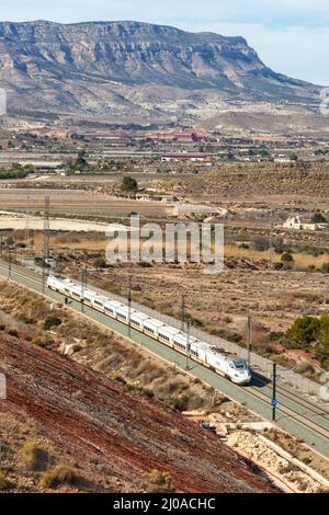 Alicante, Spain - February 16, 2022: Talgo 250 high-speed train of RENFE AVE on the Madrid - Levante high speed rail railway line near Alicante, Spain Stock Photo
