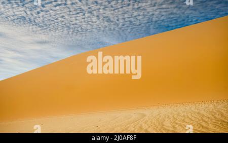 Dramatic sky over the sand dunes in the southern Sahara desert Stock Photo