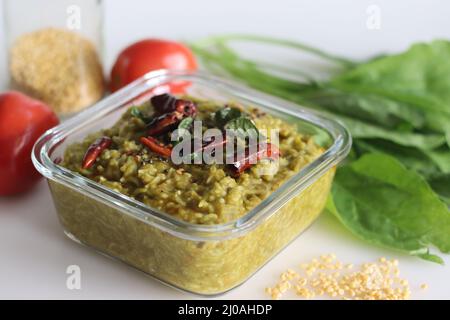 One pot preparation made of basmati rice, yellow mung lentils, blanched and pureed spinach and spices. Commonly known as palak khichdi. Shot on white Stock Photo