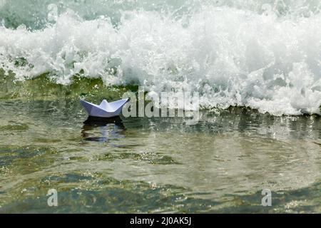 Paper boat now die in a huge wave Stock Photo