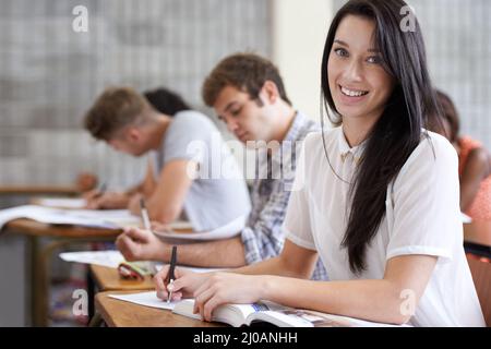 Aiming for an A. Shot of an attractive young college student studying in class. Stock Photo