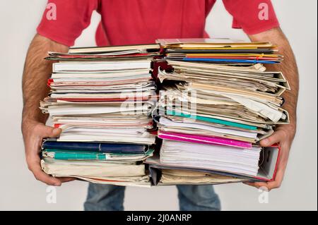 Man hold a pile of old newspapers in the hands Stock Photo