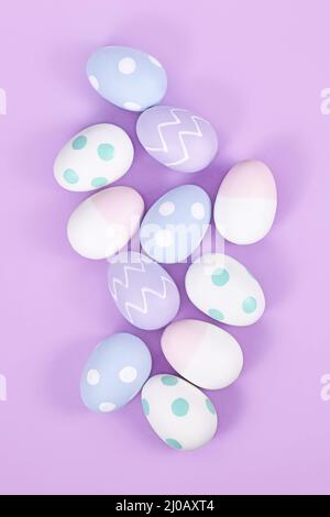 Top view of group of pastel colored easter eggs on violet background Stock Photo