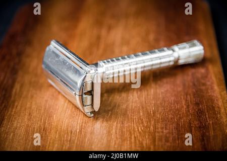 Old classic vintage shaver razor on a wooden background Stock Photo