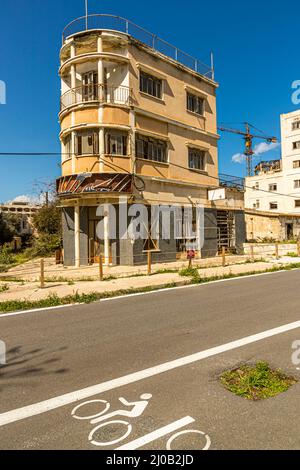 The district of Varosha (Kapalı Maraş) in Famagusta (Cyprus) was between 1970 and 1974 one of the most popular tourist destinations in the world. Its Greek Cypriot inhabitants fled during the Turkish invasion of Cyprus in 1974, when the city of Famagusta came under Turkish control. It has remained abandoned ever since and the buildings have decayed. Most of Varosha’s original inhabitants (and their direct descendants) now live south of Cyprus's UN buffer zone. Those families are still the legal owners of property in Varosha, but while the town is fought over, they cannot reclaim it. Plus, many Stock Photo