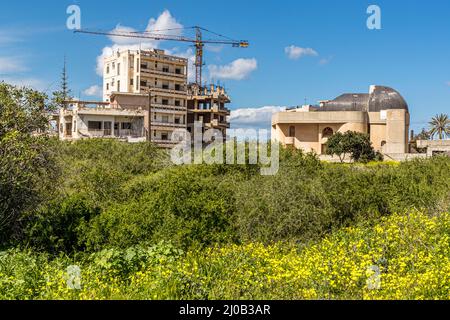 The district of Varosha (Kapalı Maraş) in Famagusta (Cyprus) was between 1970 and 1974 one of the most popular tourist destinations in the world. Its Greek Cypriot inhabitants fled during the Turkish invasion of Cyprus in 1974, when the city of Famagusta came under Turkish control. It has remained abandoned ever since and the buildings have decayed. Stock Photo