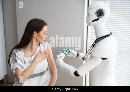 Robot Doctor Injecting Patient Arm With Vaccine Stock Photo