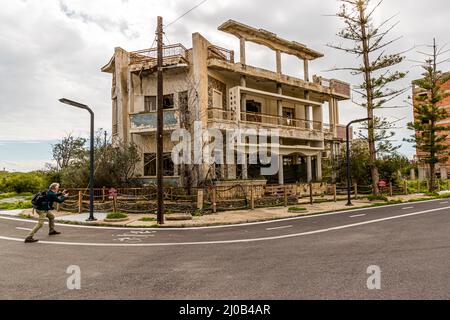 The district of Varosha (Kapalı Maraş) in Famagusta (Cyprus) was between 1970 and 1974 one of the most popular tourist destinations in the world. Its Greek Cypriot inhabitants fled during the Turkish invasion of Cyprus in 1974, when the city of Famagusta came under Turkish control. It has remained abandoned ever since and the buildings have decayed. Most of Varosha’s original inhabitants (and their direct descendants) now live south of Cyprus's UN buffer zone. Those families are still the legal owners of property in Varosha, but while the town is fought over, they cannot reclaim it. Plus, many Stock Photo