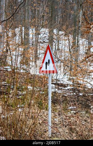 Vertical shot of a warning reverse curve or double curve traffic sign Stock Photo