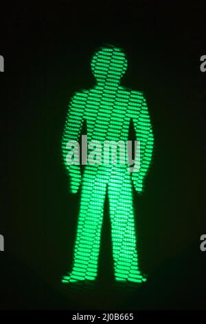 Green man go pedestrian traffic light Stock Photo