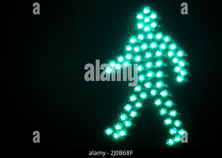 Green man go pedestrian traffic light Stock Photo