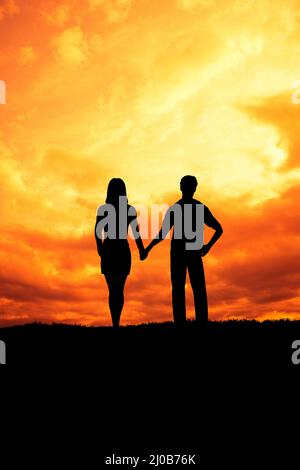 couple hand in hand at sunset Stock Photo