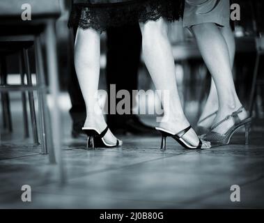 Feet of female wedding guests in heel shoes in party Stock Photo