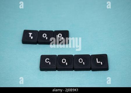 "Too Cool" inscription written with keyboard keys isolated on blue background Stock Photo