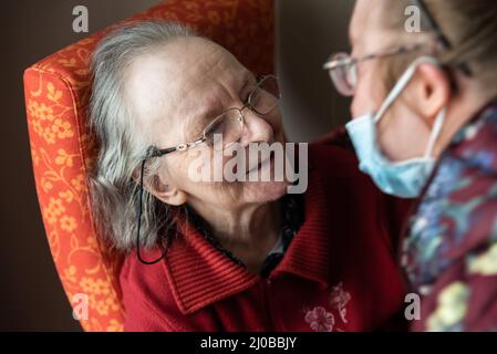 83 year old mother holding her daughter with the Down Syndrome, Tienen Stock Photo