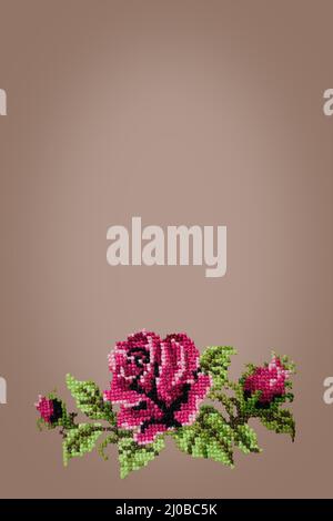 Cross embroidered rose on beige  background Stock Photo