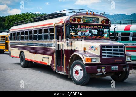 Maroon and Beige Jeepney bus truck Parked on The Side Stock Photo