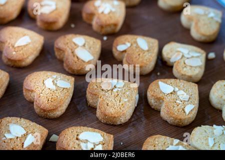 Closeup of a group of assorted Heart cookies. Chocolate , cheese and strawberry , oatmeal , white chocolate fill the frame. Homemade cookies on table. Stock Photo