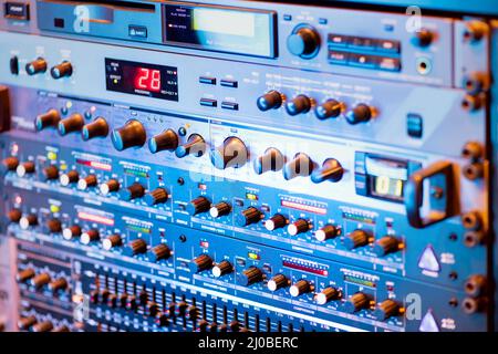 Modern music amplifier with control panel having plenty of switch placed in parallel rows Stock Photo