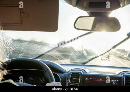 In the car on the highway with backlight and dirty windshield Stock Photo