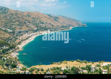 The bay of Giardini-Naxos with the Etna and Catania in the background viewed from Taormina Stock Photo