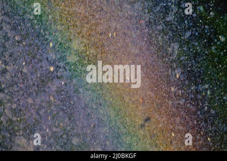 Background rainbow in the spray of a fountain closeup Stock Photo
