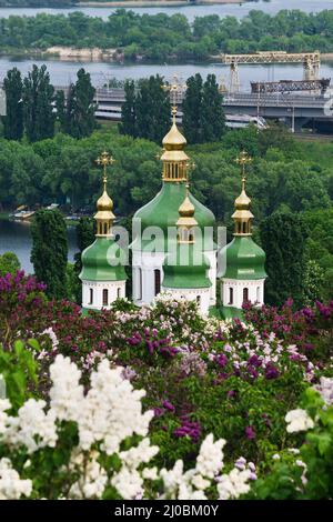 Vertical image with Vydubychi Monastery among blossoming lilac in Kiev Stock Photo