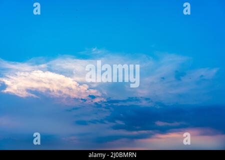 Twilight sky with some fluffy clouds in the summer Stock Photo